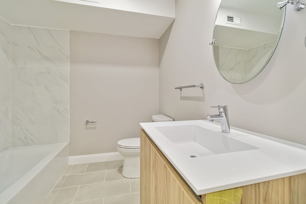 192 Main Street, Unit D Medway, MA 02053 - Photo 24 of 39 a bathroom with a sink a toilet and a bathtub