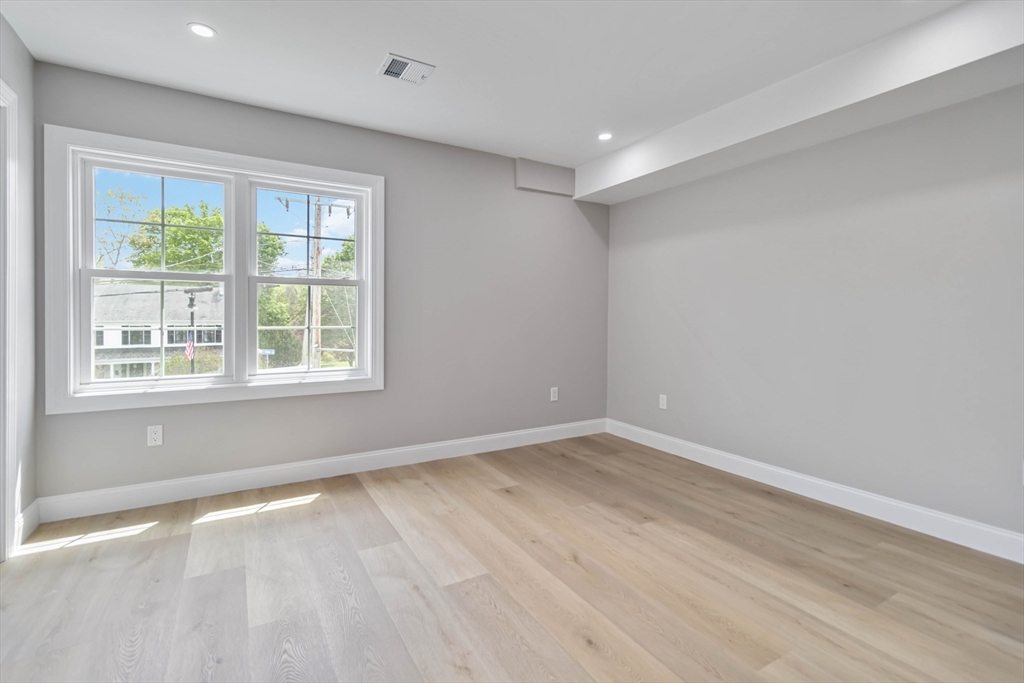192 Main Street, Unit D Medway, MA 02053 - Photo 27 of 39 wooden floor in an empty room with a window
