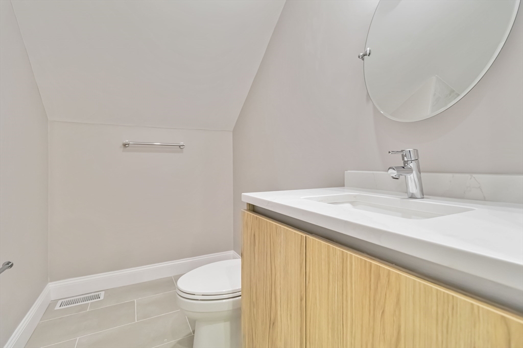 192 Main Street, Unit D Medway, MA 02053 - Photo 33 of 39 a bathroom with a sink a toilet and a mirror