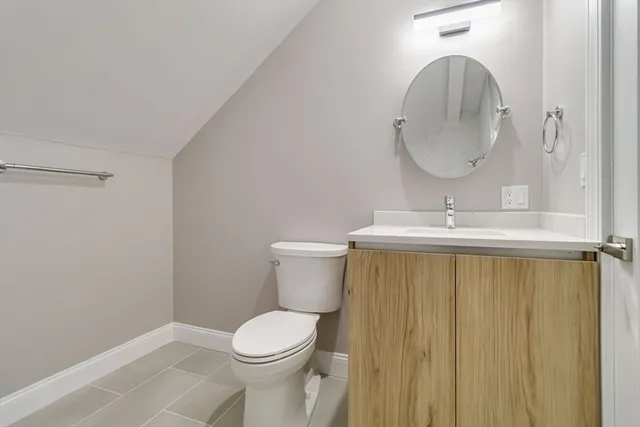 a bathroom with a sink a toilet and a mirror
