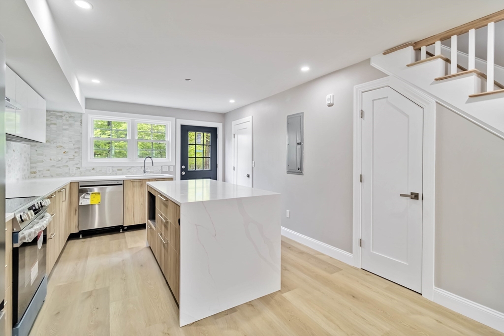192 Main Street, Unit D Medway, MA 02053 - Photo 10 of 39 a kitchen with a stove a refrigerator and a sink