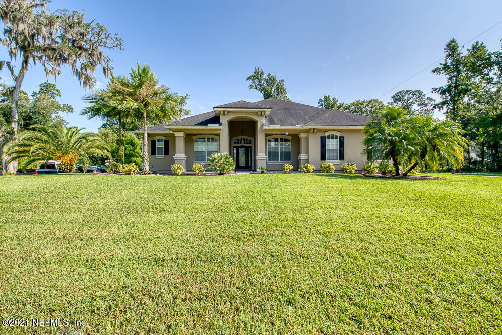 11590 Mandarin Road Jacksonville, FL 32223 - Photo 1 of 46 a front view of a house with a yard