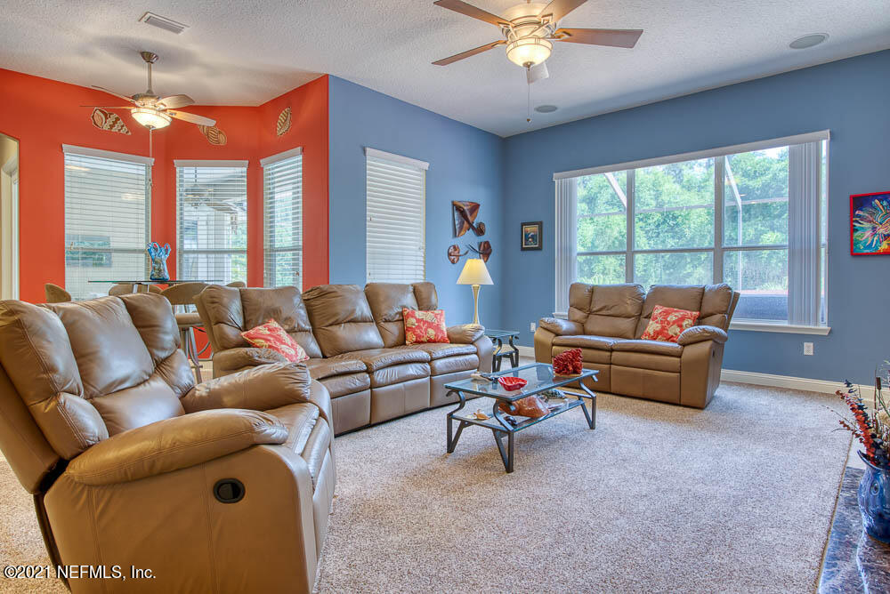 11590 Mandarin Road Jacksonville, FL 32223 - Photo 12 of 46 a living room with furniture and a large window