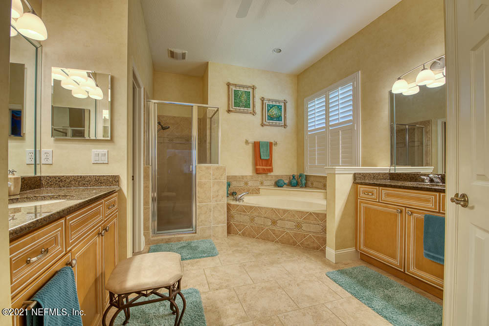 11590 Mandarin Road Jacksonville, FL 32223 - Photo 24 of 46 a spacious bathroom with a granite countertop sink mirror and a bathtub