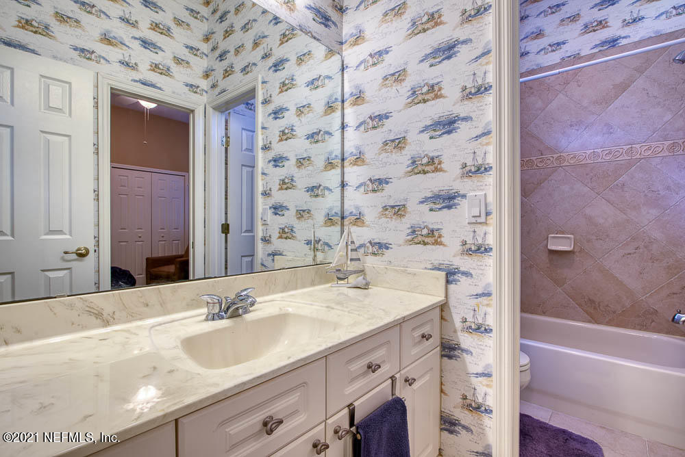11590 Mandarin Road Jacksonville, FL 32223 - Photo 26 of 46 a bathroom with a sink and a mirror