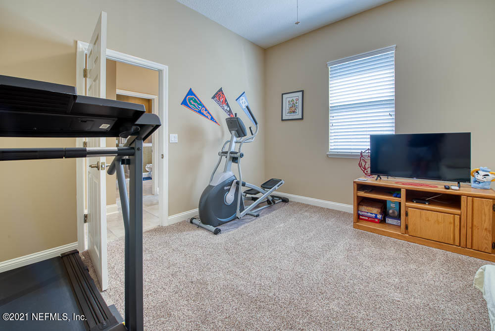 11590 Mandarin Road Jacksonville, FL 32223 - Photo 28 of 46 a view of a livingroom with furniture and a flat screen tv