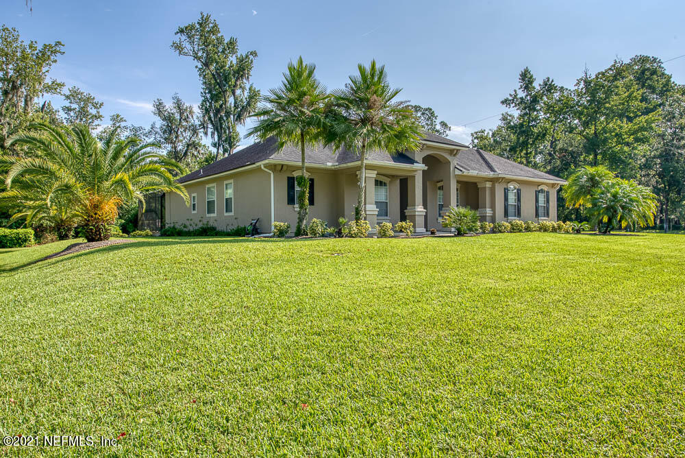 11590 Mandarin Road Jacksonville, FL 32223 - Photo 37 of 46 a front view of house with yard and green space