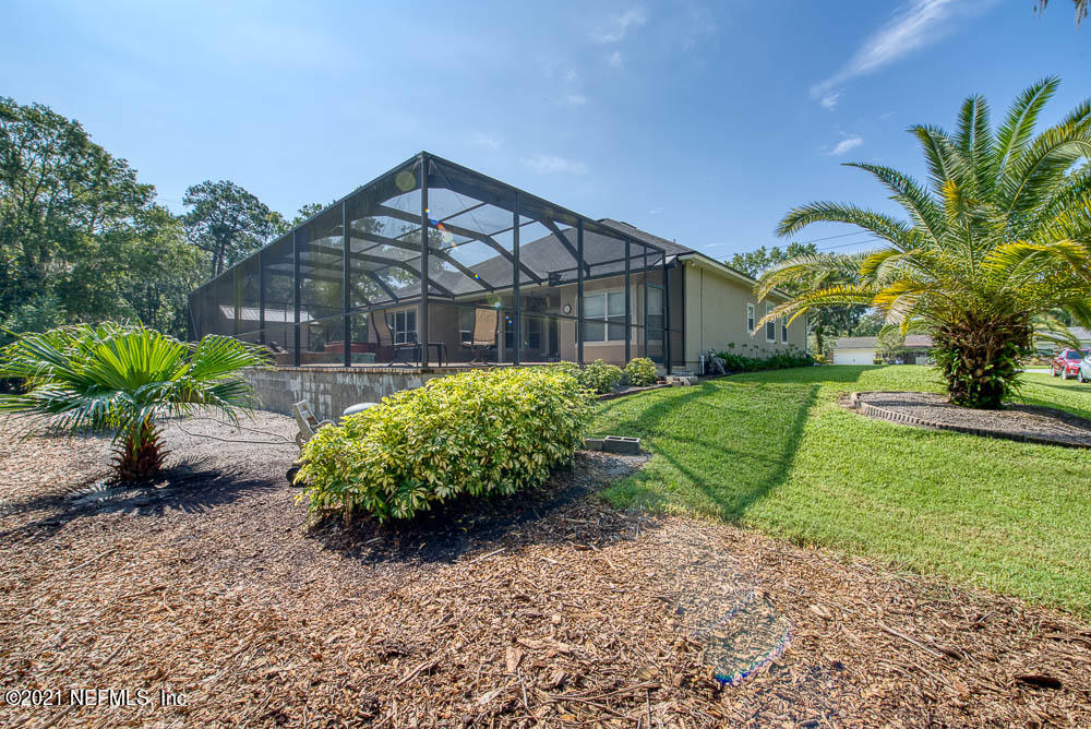11590 Mandarin Road Jacksonville, FL 32223 - Photo 38 of 46 a front view of a house with a yard and a garden