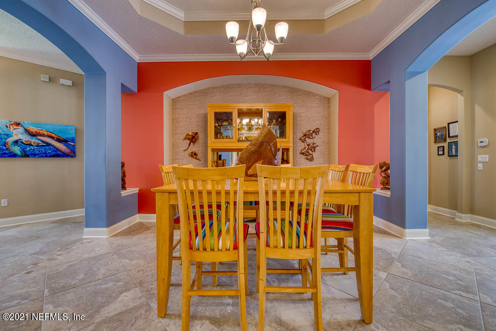 11590 Mandarin Road Jacksonville, FL 32223 - Photo 5 of 46 a view of a dining room with furniture and chandelier