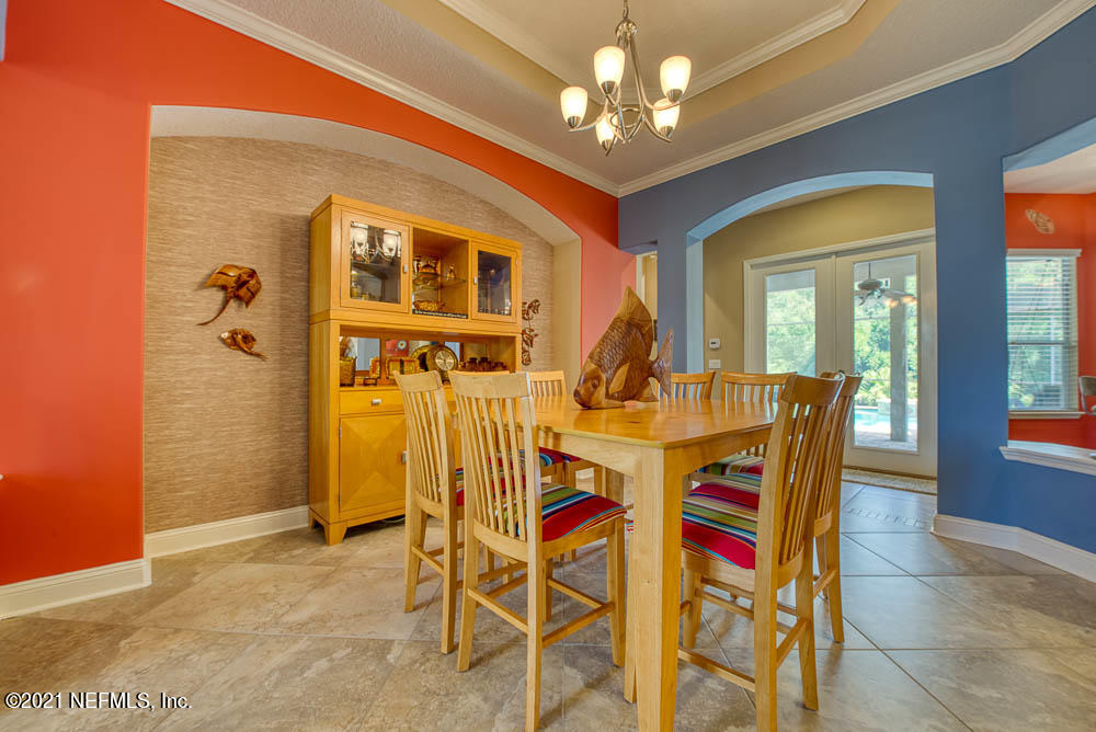 11590 Mandarin Road Jacksonville, FL 32223 - Photo 6 of 46 a view of a dining room with furniture and a chandelier