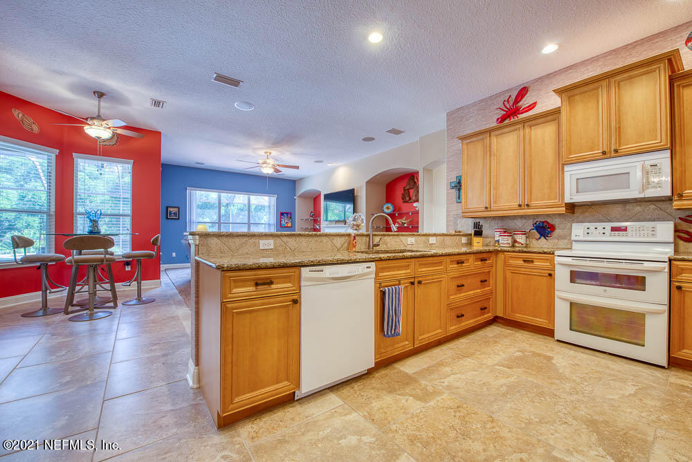 11590 Mandarin Road Jacksonville, FL 32223 - Photo 7 of 46 a kitchen with stainless steel appliances granite countertop a stove and more cabinets