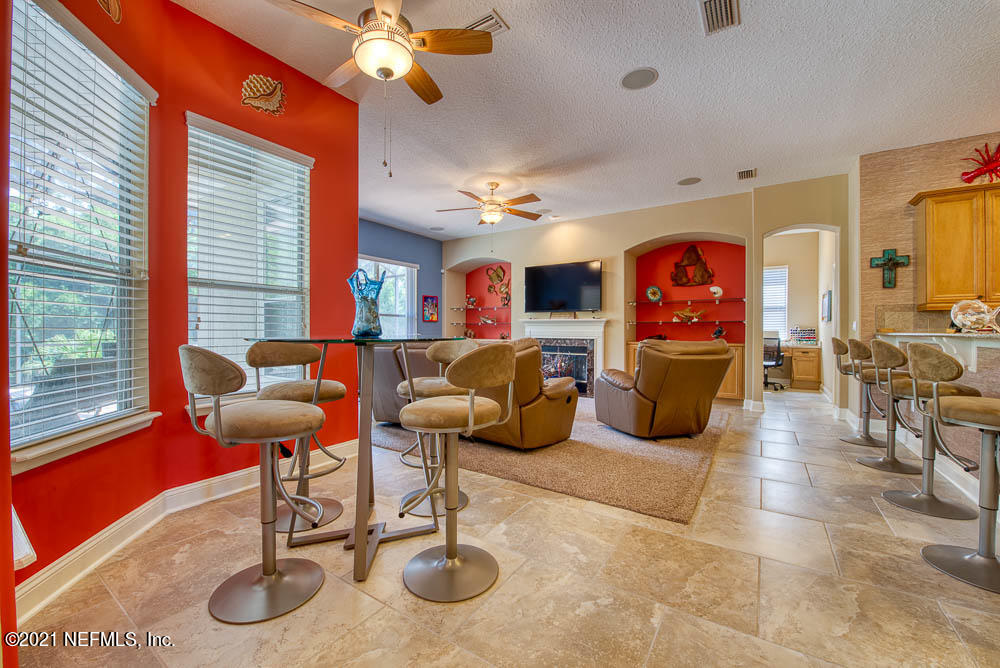 11590 Mandarin Road Jacksonville, FL 32223 - Photo 10 of 46 a living room with furniture a rug and a chandelier