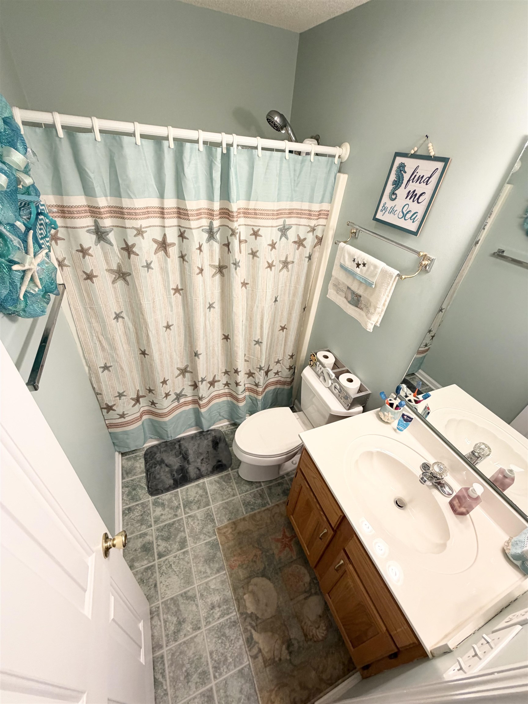 106 Sly Fox Trail Myrtle Beach, SC 29588 - Photo 12 of 14 Bathroom featuring vanity, a shower with curtain, and a textured ceiling