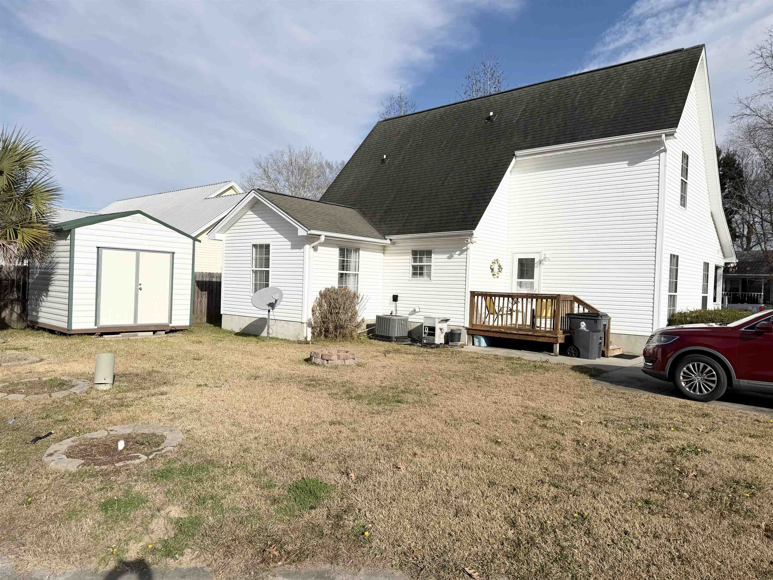 106 Sly Fox Trail Myrtle Beach, SC 29588 - Photo 14 of 14 Back of property with a storage shed, a deck, a lawn, and roof with shingles