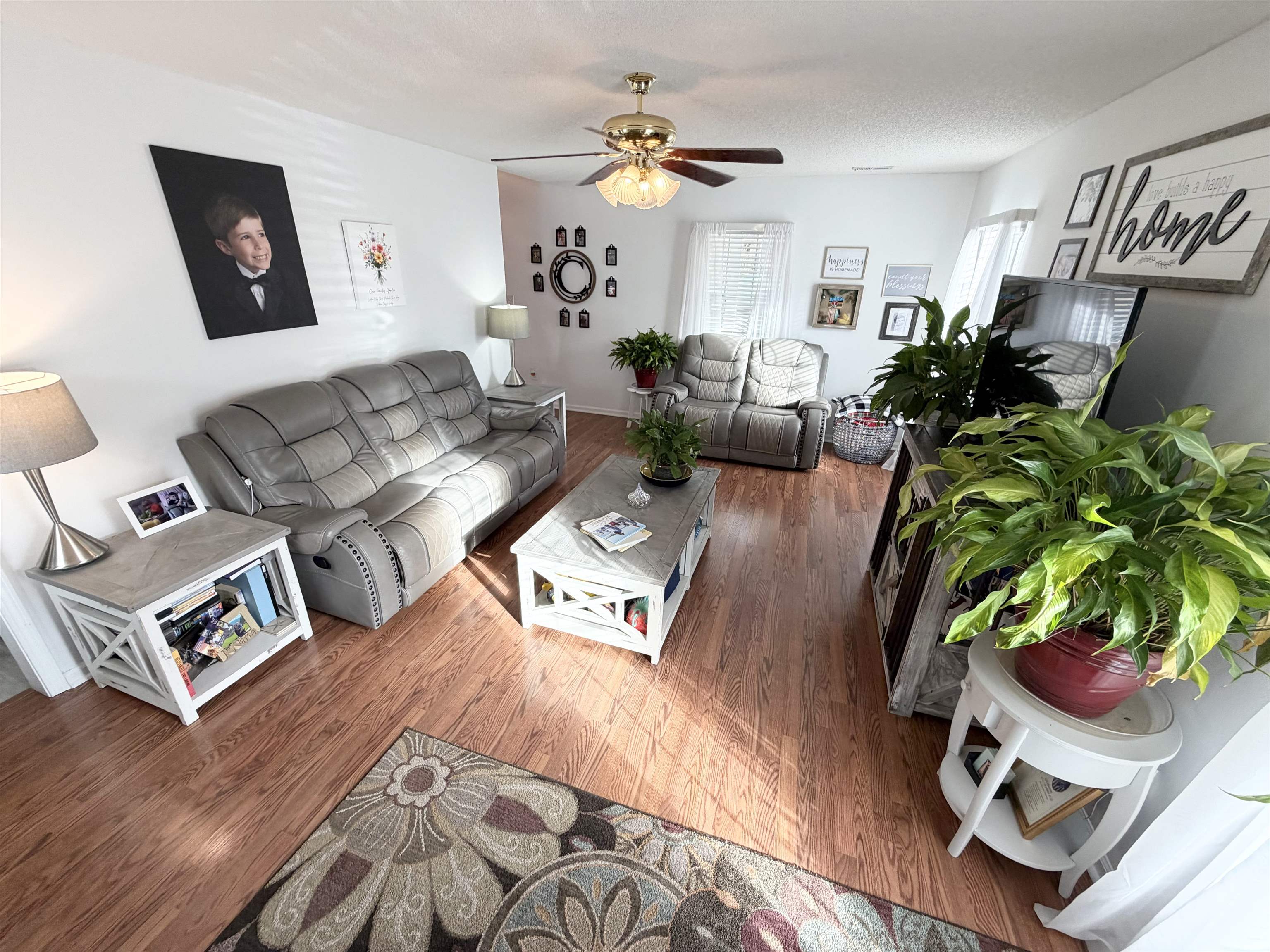106 Sly Fox Trail Myrtle Beach, SC 29588 - Photo 4 of 14 Living room featuring wood finished floors, ceiling fan, and a textured ceiling