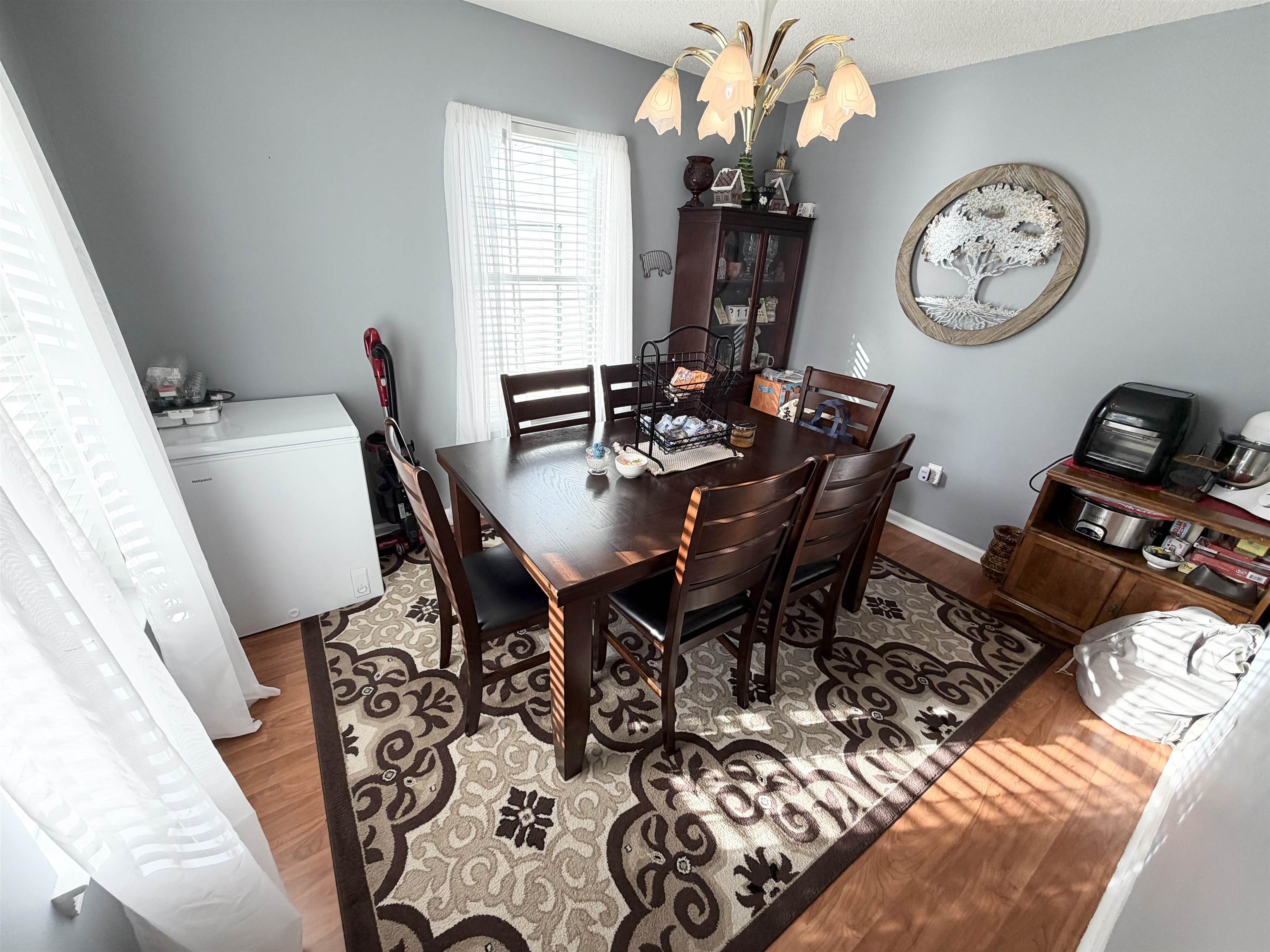 106 Sly Fox Trail Myrtle Beach, SC 29588 - Photo 5 of 14 Dining space featuring light wood-style floors and a chandelier