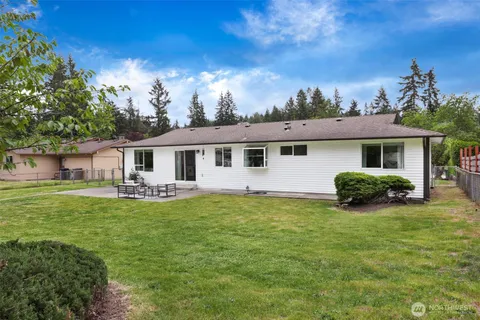 a front view of house with yard barbeque and patio