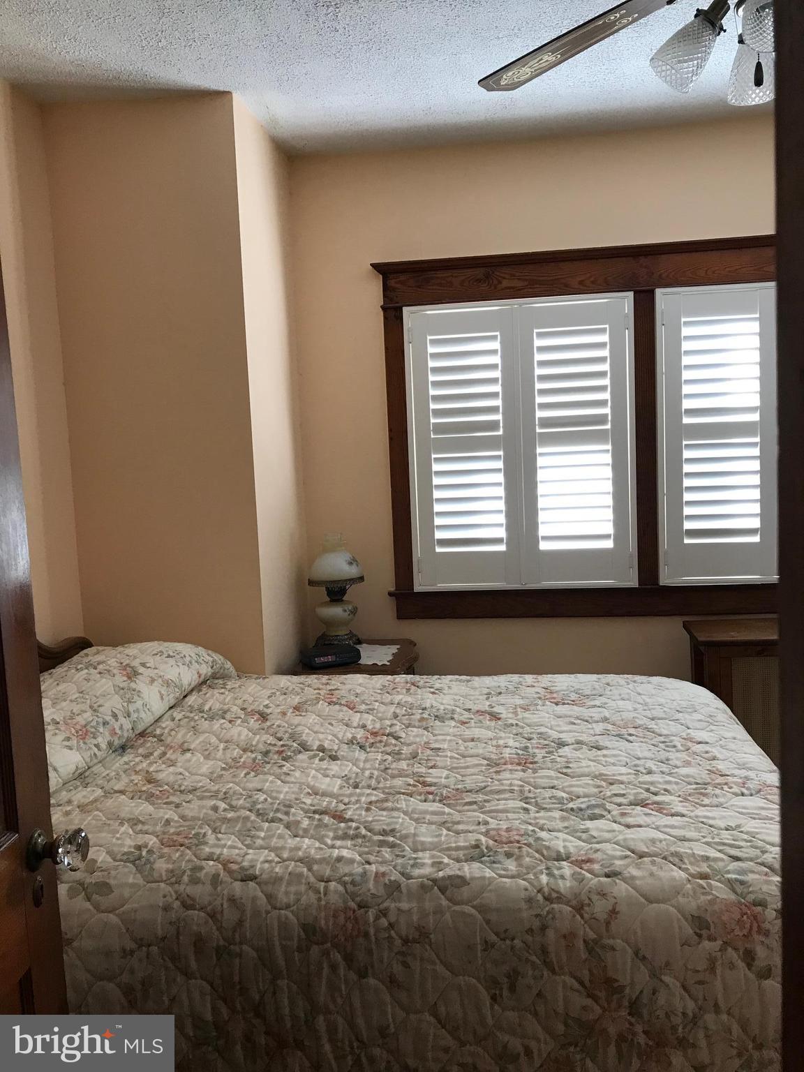 1831 Portship Road Baltimore, MD 21222 - Photo 12 of 17 a bedroom with a bed and a window