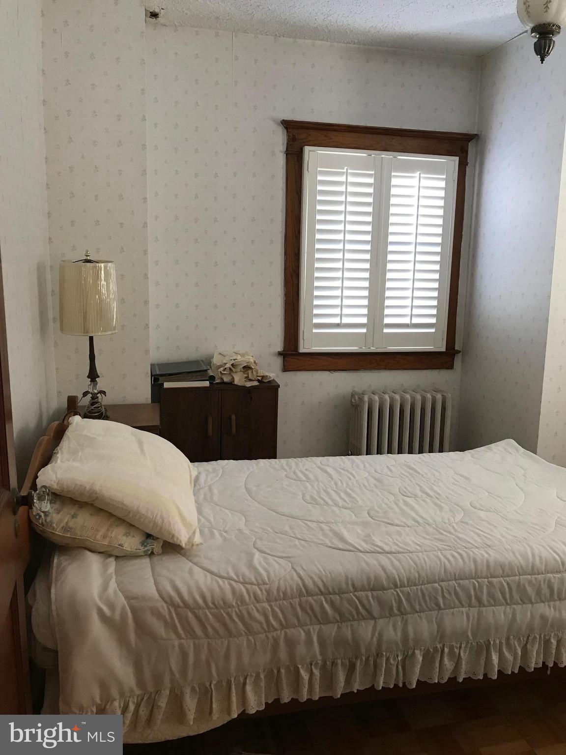 1831 Portship Road Baltimore, MD 21222 - Photo 14 of 17 a bedroom with a bed and window