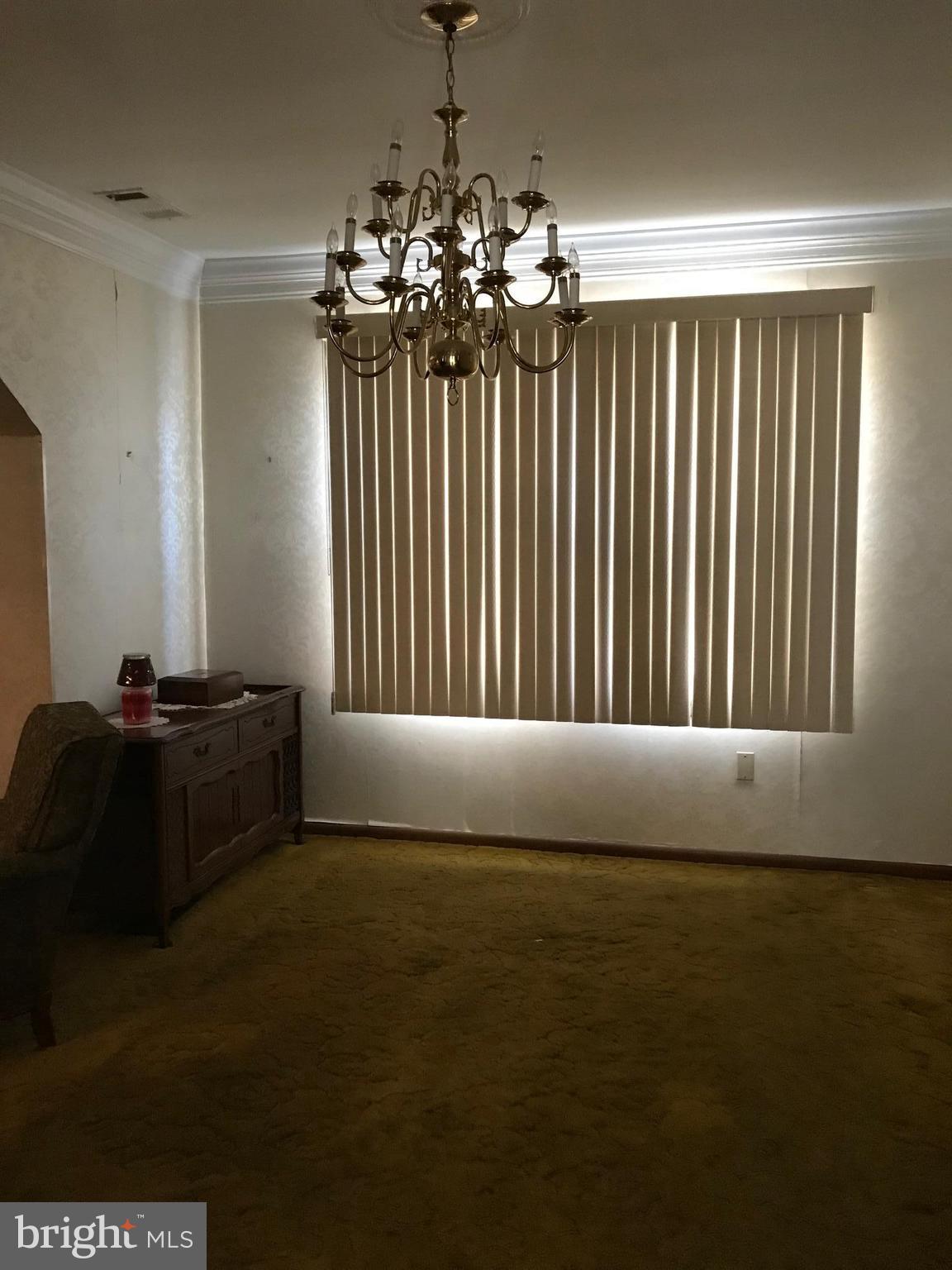 1831 Portship Road Baltimore, MD 21222 - Photo 5 of 17 a living room with furniture and a chandelier