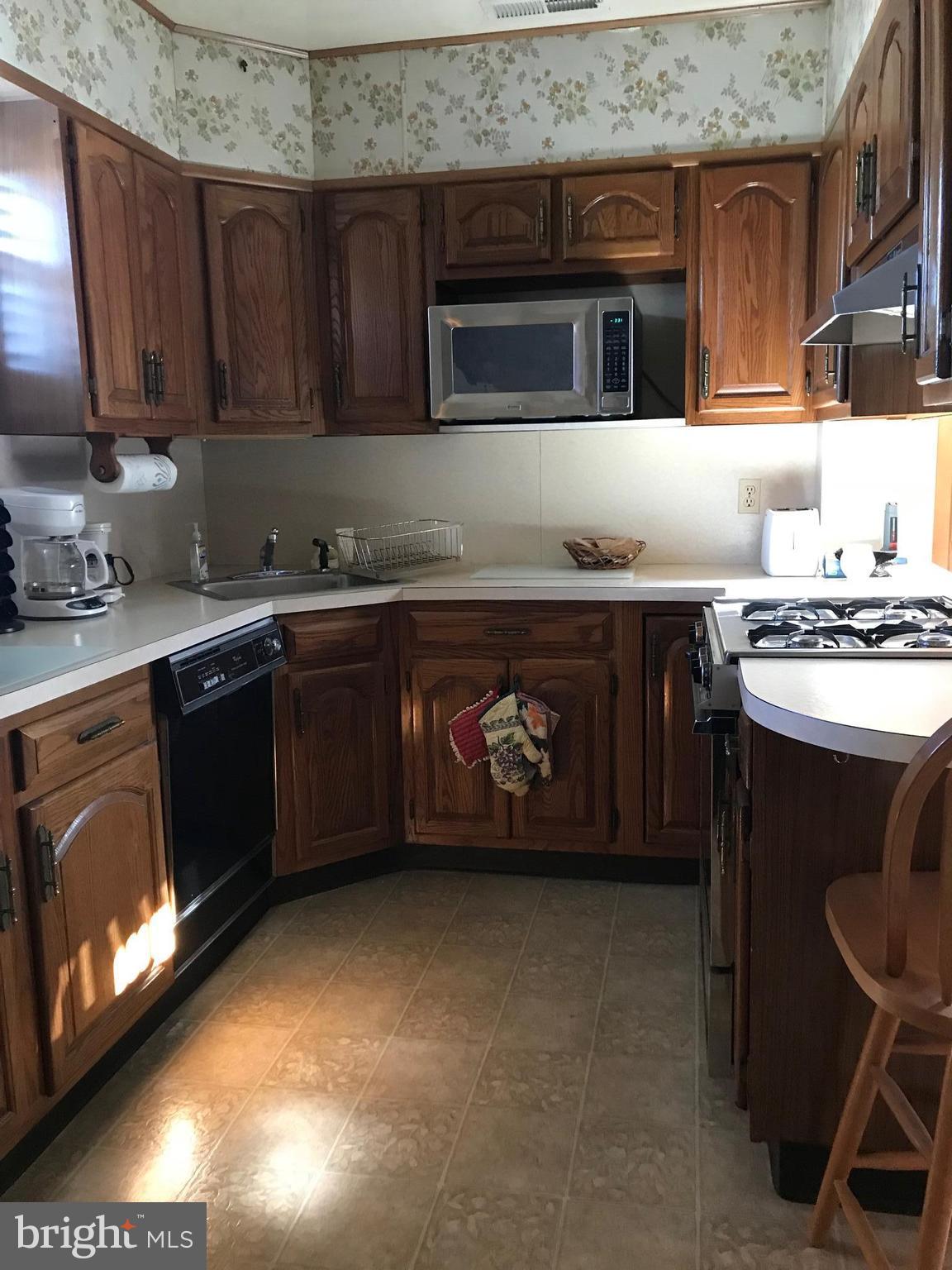 1831 Portship Road Baltimore, MD 21222 - Photo 7 of 17 a kitchen with a stove and a microwave