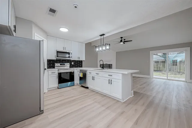 a kitchen with stainless steel appliances a refrigerator stove and sink