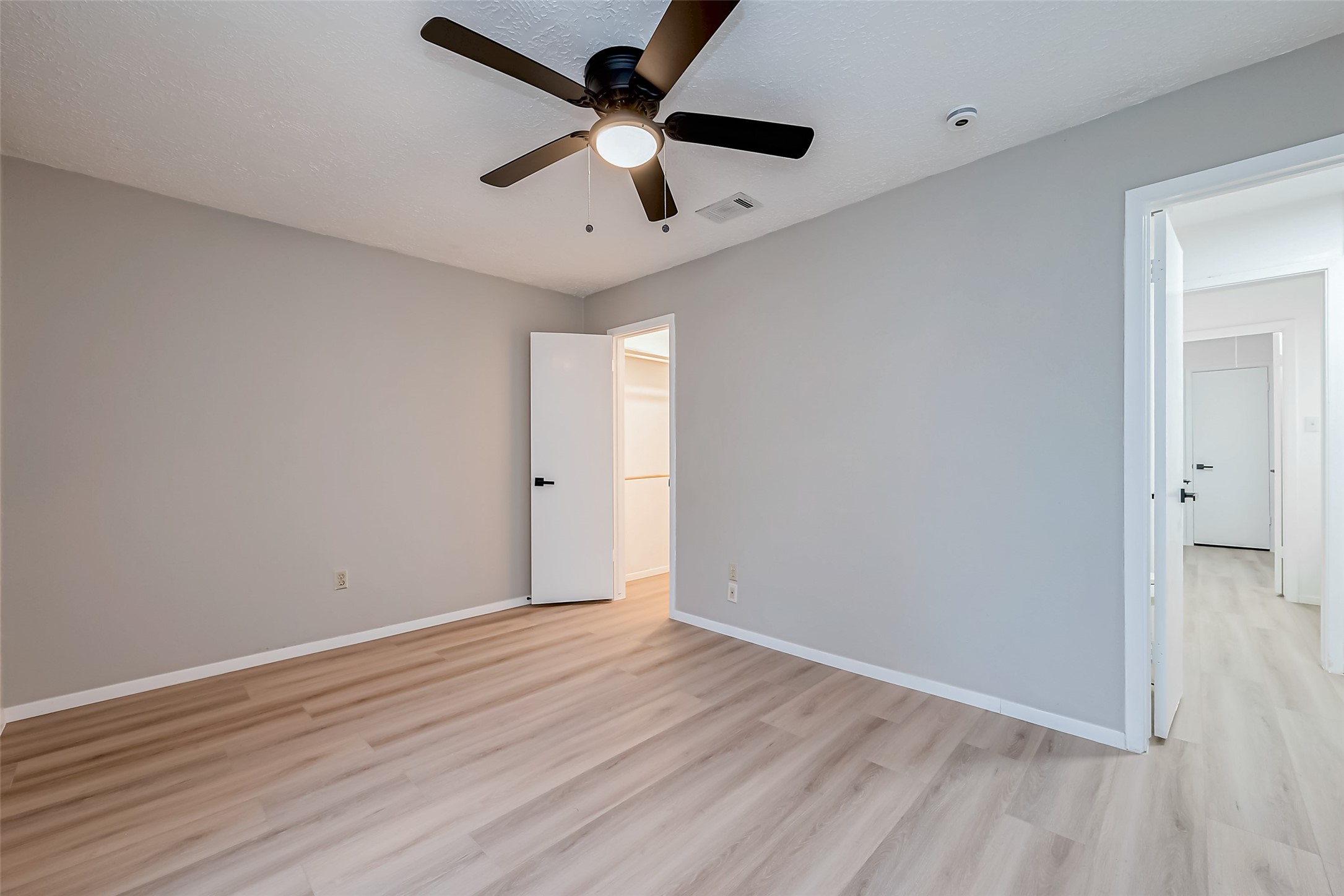 23227 Pine Post Lane Spring, TX 77373 - Photo 32 of 40 an empty room with wooden floor and a ceiling fan