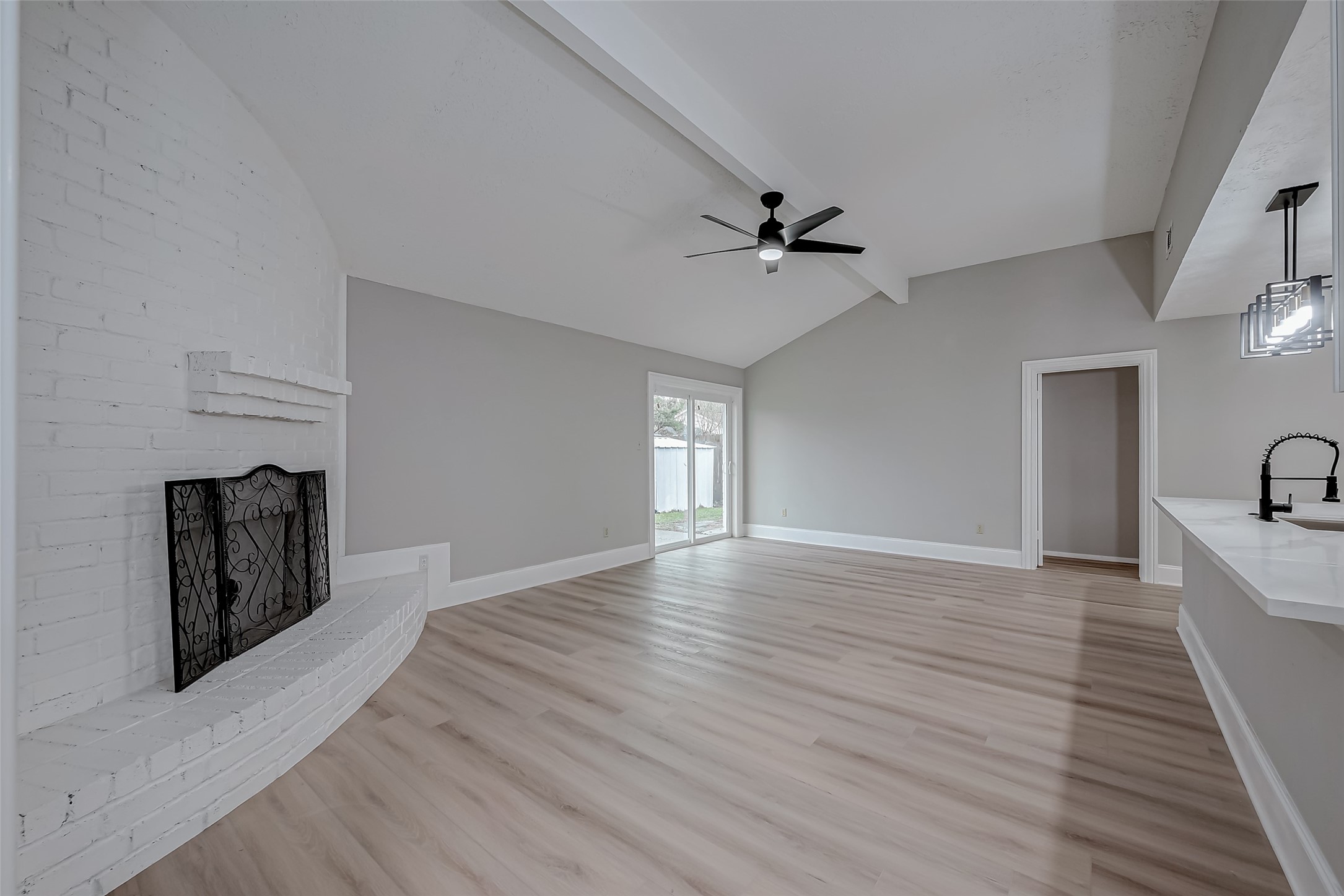 23227 Pine Post Lane Spring, TX 77373 - Photo 4 of 40 a view of a livingroom with a fireplace a ceiling fan and wooden floor