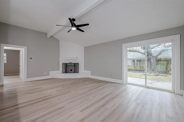 a view of kitchen and hall with wooden floor
