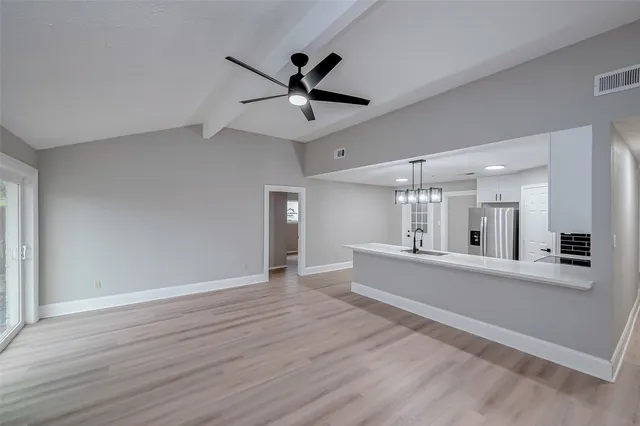 a spacious bathroom with a granite countertop sink and a mirror