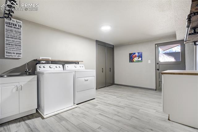 615 Castle Road Colorado Springs, CO 80904 - Photo 39 of 50 Lower level laundry with access to the outside. Sink and cabinets