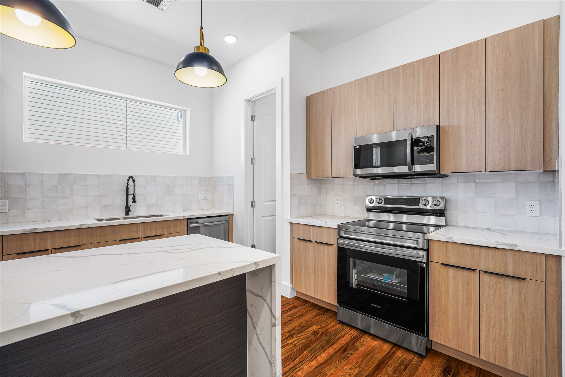 3405 Baer Street Houston, TX 77020 - Photo 12 of 28 a kitchen with stainless steel appliances a stove a sink and a microwave
