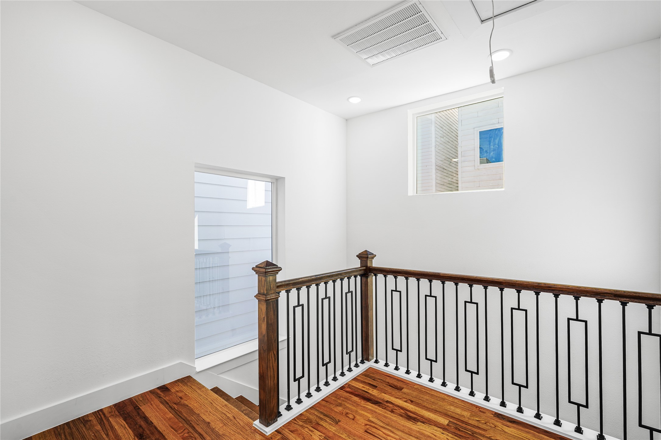 3405 Baer Street Houston, TX 77020 - Photo 24 of 28 a view of a hallway with wooden floor and a bathroom