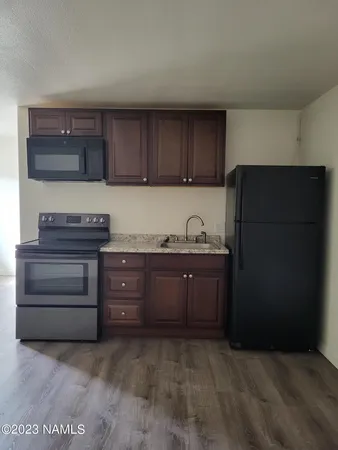 a kitchen with a refrigerator and a stove