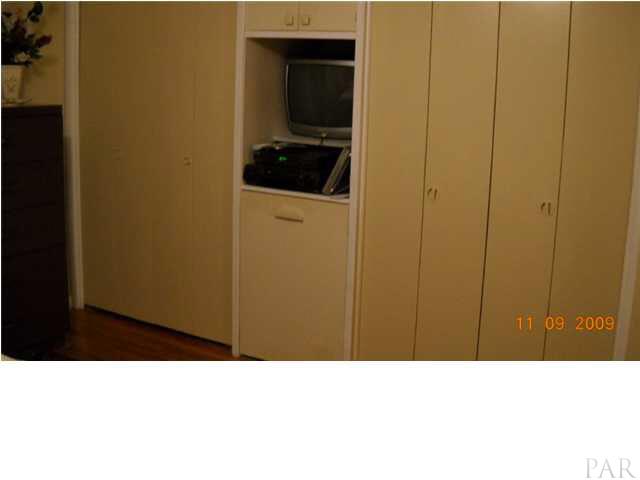 4664 Cerny Road Pensacola, FL 32526 - Photo 10 of 22 MBR closets and built in TV Cabinet and pull out shoe cabinet below