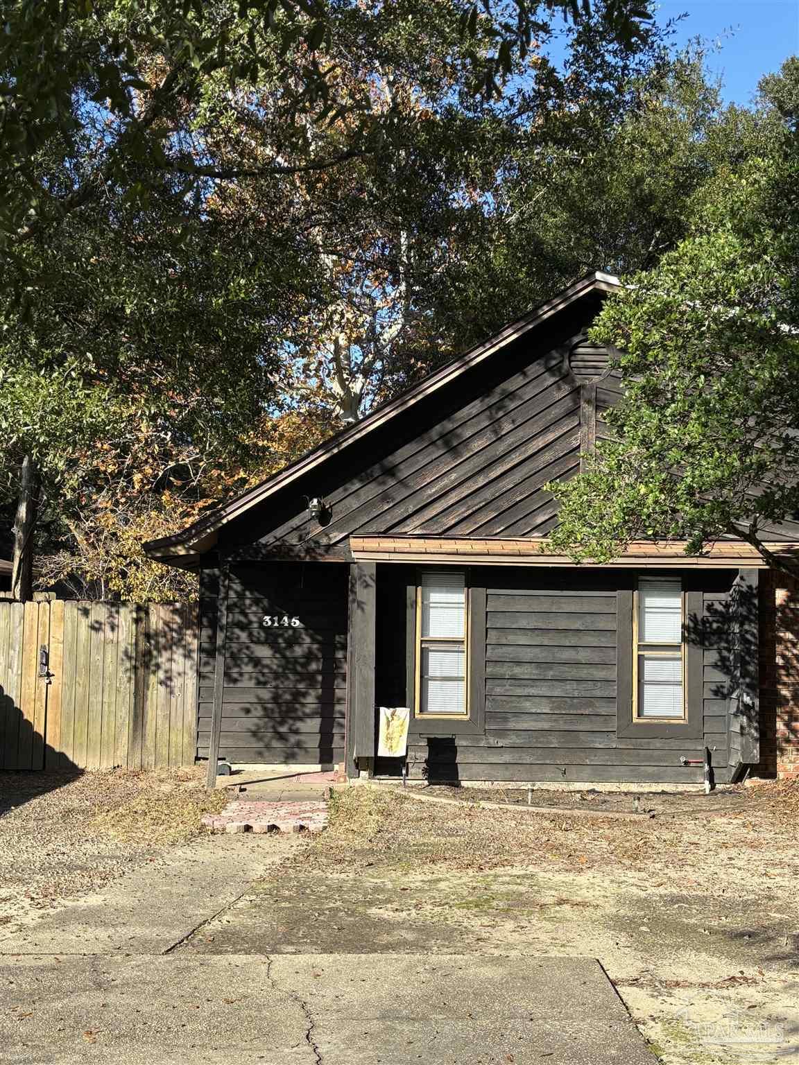 a house with trees in the background