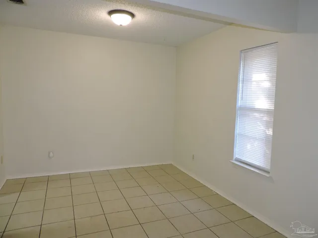 an empty room with a empty space and window