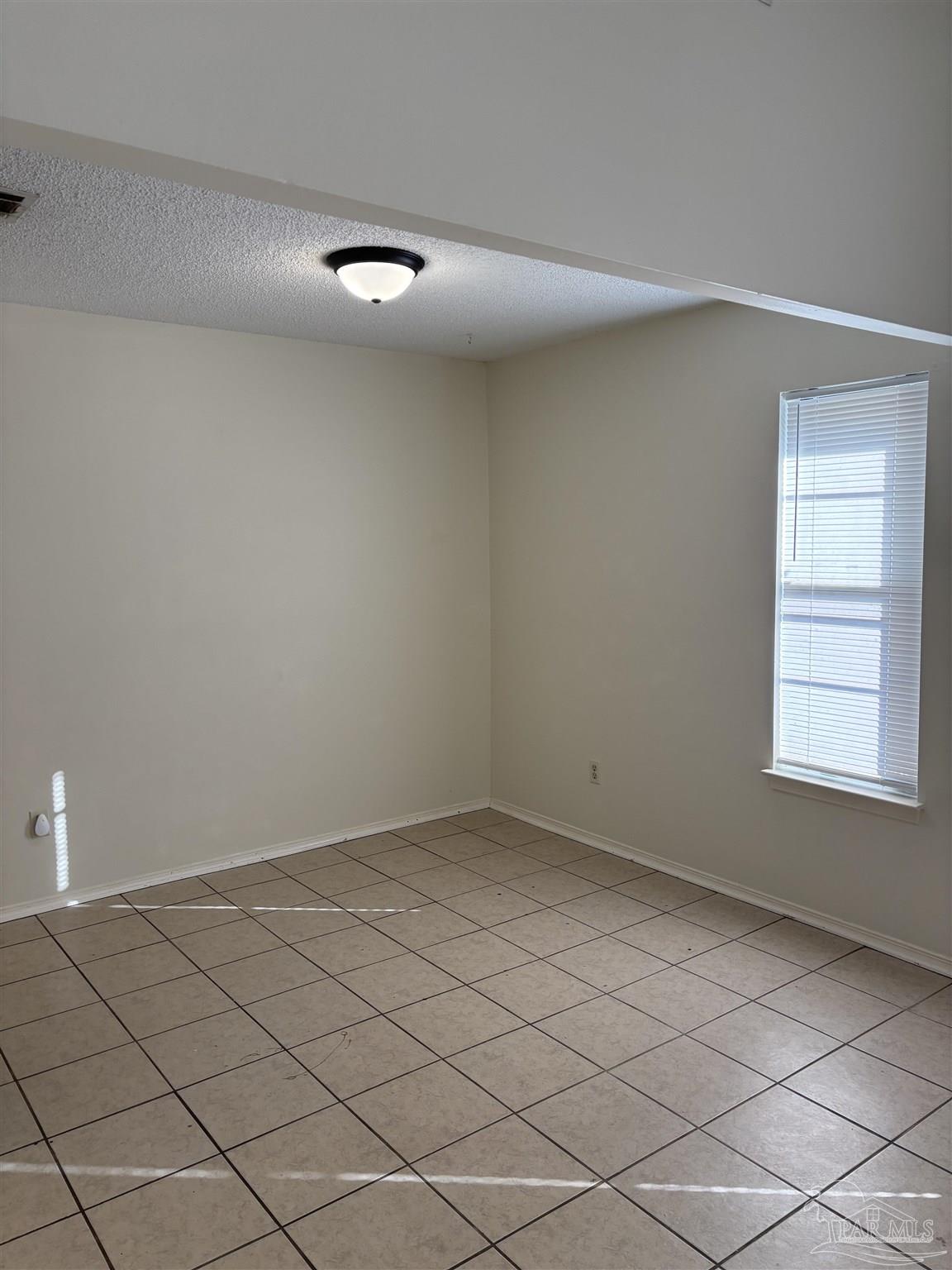 3145 Cedarwood Village Lane Pensacola, FL 32514 - Photo 4 of 11 an empty room with a window