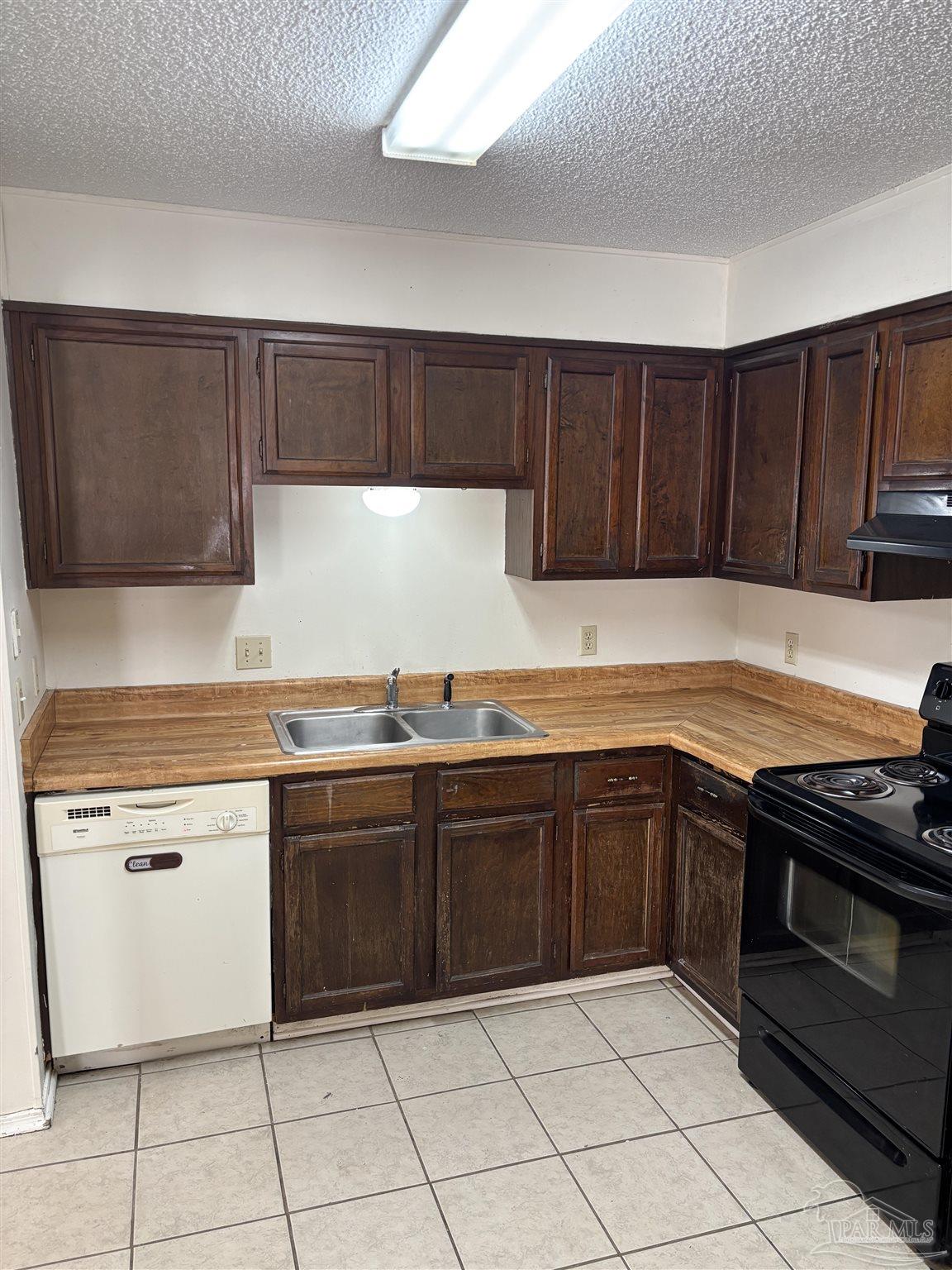 3145 Cedarwood Village Lane Pensacola, FL 32514 - Photo 5 of 11 a kitchen with granite countertop a stove top oven microwave and cabinets