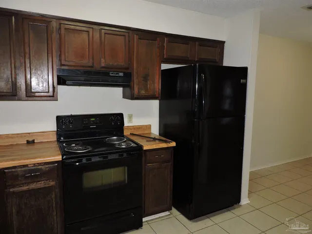 a kitchen with a sink stove and refrigerator