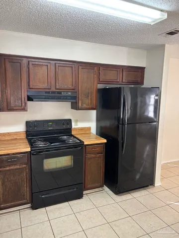 a kitchen with stainless steel appliances granite countertop a stove a refrigerator and a cabinets