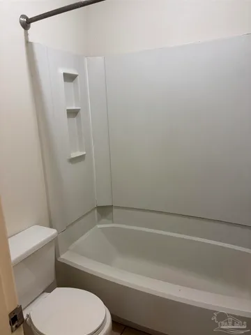 a bathroom with a toilet and a bathtub