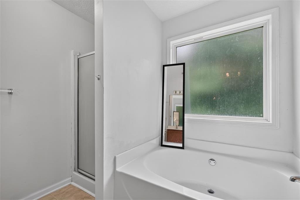 602 Pendergrass Road Winder, GA 30680 - Photo 25 of 44 a bathroom with a bathtub and shower