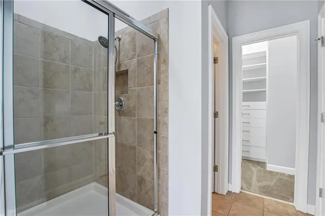 a bathroom with a glass shower door