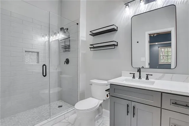 a bathroom with a sink toilet and shower