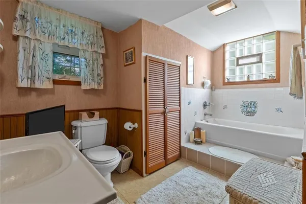 a bathroom with a toilet a sink and bathtub