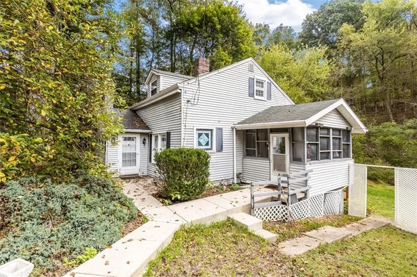a front view of house with yard outdoor seating and barbeque oven