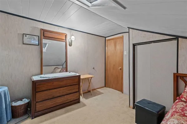 a room with a bed and a mirror