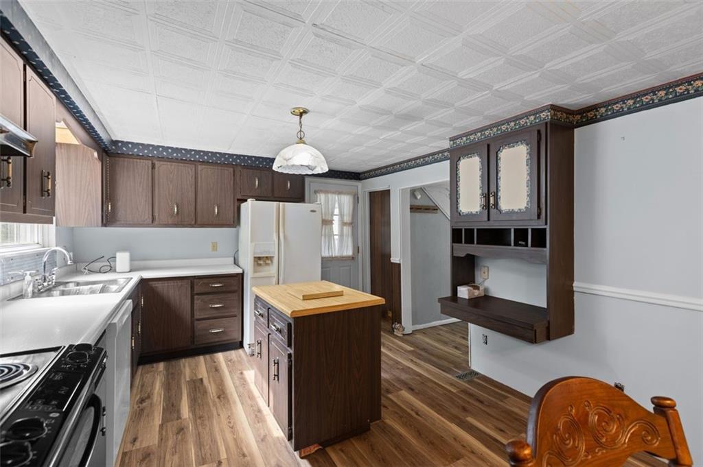 5879 Steele Road Murrysville, PA 15668 - Photo 10 of 27 a kitchen with stainless steel appliances a stove refrigerator sink and cabinets