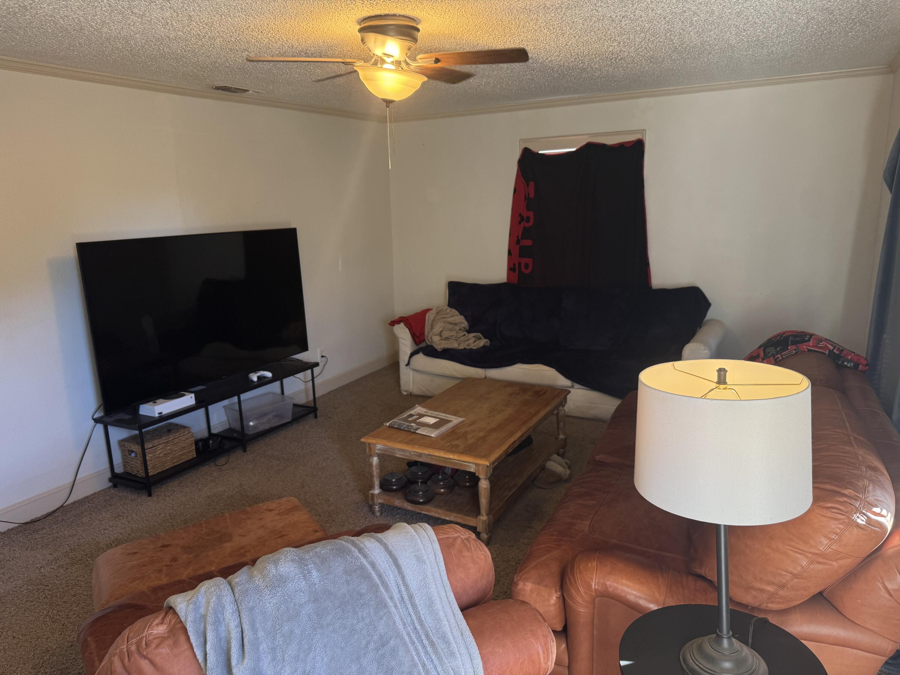 2610 27th Street Lubbock, TX 79410 - Photo 3 of 7 a living room with furniture and a flat screen tv